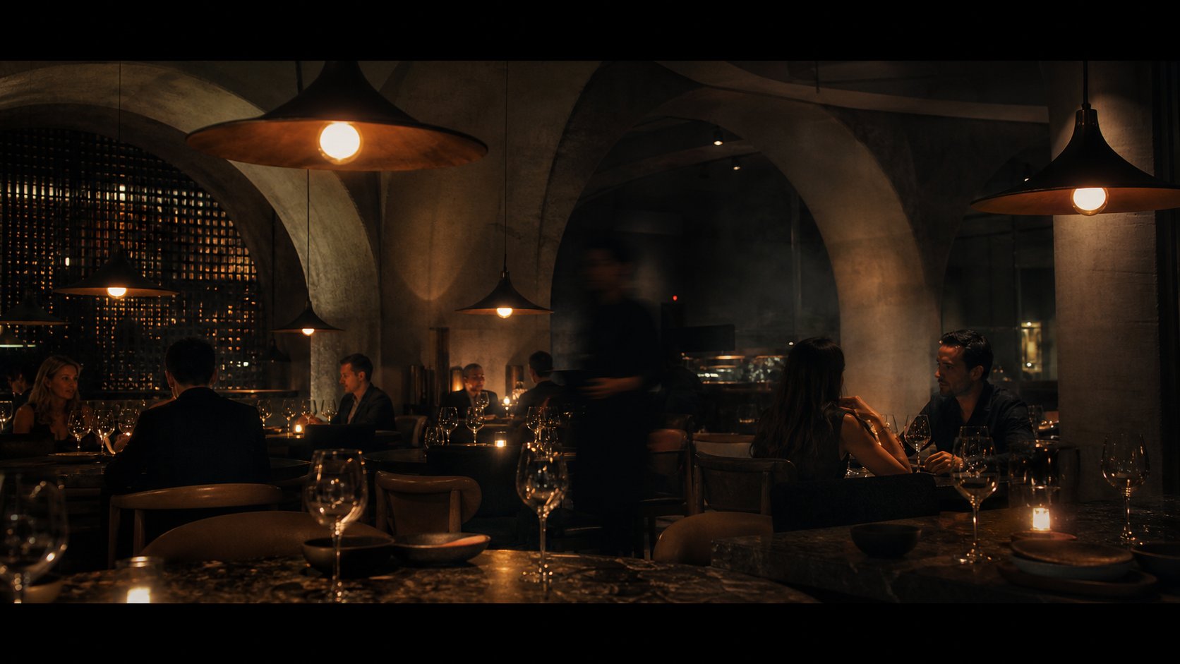 Amber lamps above stone tables inside Ombra restaurant